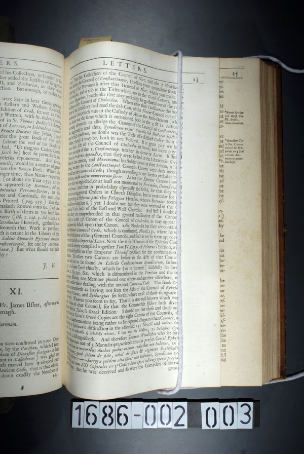Book open to display paper specimens